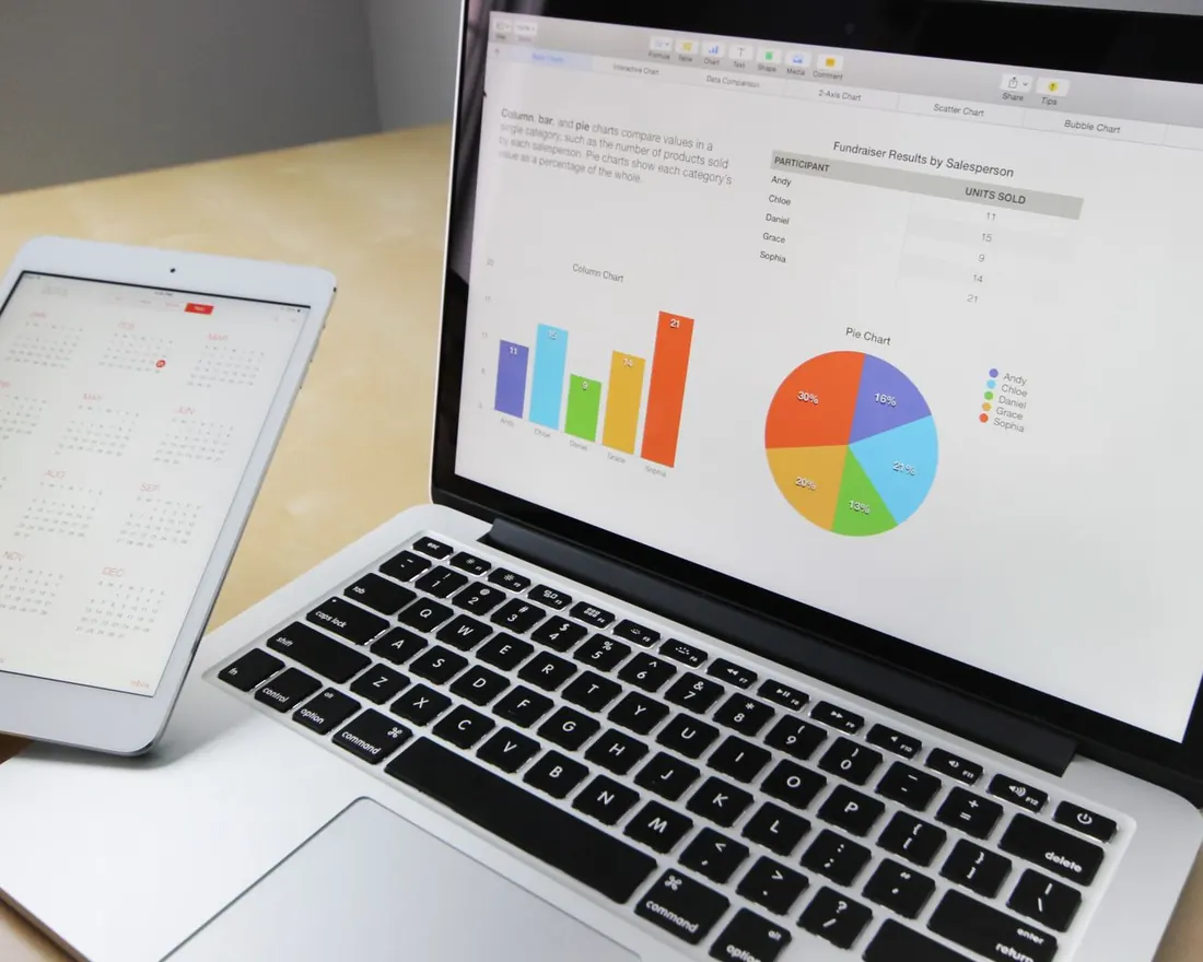Laptop and tablet showing search performance charts on a desk