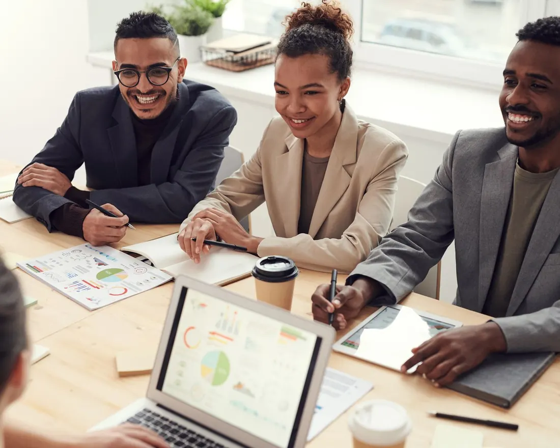 Agency team reviewing client reports together around a meeting table
